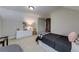 Inviting bedroom featuring neutral walls, a dresser, and a comfortable bed with patterned accents at 1738 Honey Tree Pl, Hoschton, GA 30548