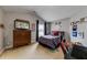 Inviting bedroom with a plaid bedspread, a dresser with a TV, and sports-themed decor at 1738 Honey Tree Pl, Hoschton, GA 30548
