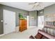 Comfortable bedroom with a wood dresser, a TV, and a leather recliner, providing a relaxing retreat at 1738 Honey Tree Pl, Hoschton, GA 30548