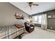 Cozy bedroom featuring a comfortable recliner, a single bed, and plenty of natural light at 1738 Honey Tree Pl, Hoschton, GA 30548