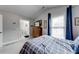 Bedroom featuring a plaid bed, a dresser with a TV, and a view into an ensuite bathroom at 1738 Honey Tree Pl, Hoschton, GA 30548