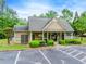 Charming clubhouse with well-maintained landscaping, parking, and inviting entrance, nestled in a leafy green community at 1738 Honey Tree Pl, Hoschton, GA 30548