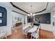 Elegant dining room featuring hardwood floors, modern chandelier, and stylish decor at 1738 Honey Tree Pl, Hoschton, GA 30548