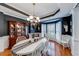 Elegant dining room featuring hardwood floors, a white table, and bay window at 1738 Honey Tree Pl, Hoschton, GA 30548