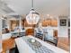Charming dining room featuring a chandelier, open to kitchen, and hardwood floors throughout at 1738 Honey Tree Pl, Hoschton, GA 30548