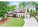 Charming brick two-story home with a manicured front yard and two car garage at 1738 Honey Tree Pl, Hoschton, GA 30548