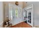 Bright foyer with hardwood floors, decorative glass door, and access to the study at 1738 Honey Tree Pl, Hoschton, GA 30548