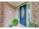 Inviting front entrance with a decorative blue door and brick facade at 1738 Honey Tree Pl, Hoschton, GA 30548