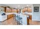 Well-equipped kitchen featuring wood cabinets, modern appliances, and a breakfast bar at 1738 Honey Tree Pl, Hoschton, GA 30548