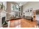 Bright living room featuring high ceilings, large windows, and a fireplace at 1738 Honey Tree Pl, Hoschton, GA 30548