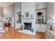 Inviting living room with a cozy fireplace, built-in shelves, and warm hardwood floors at 1738 Honey Tree Pl, Hoschton, GA 30548