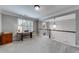 Bright loft space with neutral walls, a desk near the window, and a view of the staircase at 1738 Honey Tree Pl, Hoschton, GA 30548