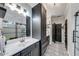 Modern main bathroom featuring a stand alone shower, tile floors, and black cabinets at 1738 Honey Tree Pl, Hoschton, GA 30548