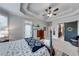 Spacious main bedroom with tray ceiling, plush carpet, access to ensuite, and barn door at 1738 Honey Tree Pl, Hoschton, GA 30548