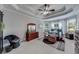 Spacious main bedroom with tray ceiling, plush carpet, windows, and barn door at 1738 Honey Tree Pl, Hoschton, GA 30548