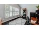 Bright office featuring white shutters, dark wood floors and a patterned grey rug at 1738 Honey Tree Pl, Hoschton, GA 30548