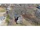 An aerial view of a cozy house with a detached garage and a lush, tree-filled surrounding landscape at 2651 Old Lost Mountain Rd, Powder Springs, GA 30127