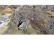 An aerial view of a cozy house with a detached garage and a lush, tree-filled surrounding landscape at 2651 Old Lost Mountain Rd, Powder Springs, GA 30127