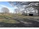Large backyard with trees and storage shed at 2651 Old Lost Mountain Rd, Powder Springs, GA 30127