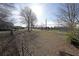 View of the expansive backyard with a chain-link fence and bare trees at 2651 Old Lost Mountain Rd, Powder Springs, GA 30127