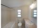 Clean bathroom featuring a shower-tub combo, with a neutral vanity and updated lighting fixture at 2651 Old Lost Mountain Rd, Powder Springs, GA 30127