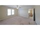 Spacious bedroom with neutral paint, carpet, ceiling fan, and access to another room at 2651 Old Lost Mountain Rd, Powder Springs, GA 30127