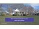 Charming single-story farmhouse featuring a cozy front porch and beautiful, established landscaping at 2651 Old Lost Mountain Rd, Powder Springs, GA 30127