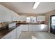 Bright kitchen with white cabinets, stainless steel appliances, and ample counter space for meal preparation at 2651 Old Lost Mountain Rd, Powder Springs, GA 30127