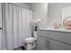 Bathroom featuring a gray vanity, toilet, and shower with patterned curtain at 312 Wichita Way, Mcdonough, GA 30253