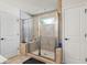 Large glass shower with built-in bench, rain shower head, and body sprayers at 312 Wichita Way, Mcdonough, GA 30253