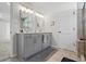 Bathroom with gray double sink vanity and luxurious tile flooring, modern fixtures at 312 Wichita Way, Mcdonough, GA 30253