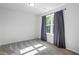 Bedroom with plush carpet and lots of natural light from the large window at 312 Wichita Way, Mcdonough, GA 30253