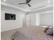 This spacious bedroom features a tray ceiling, ceiling fan, and large television at 312 Wichita Way, Mcdonough, GA 30253