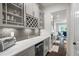 Butler's pantry featuring gray cabinets, stylish backsplash and countertops, with a wine rack and space for appliances at 312 Wichita Way, Mcdonough, GA 30253