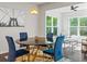 Chic dining area with designer lighting, a marble-top table, and modern blue chairs at 312 Wichita Way, Mcdonough, GA 30253