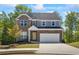 Charming two-story home with brick and stone accents, a well-manicured lawn and attached two-car garage at 312 Wichita Way, Mcdonough, GA 30253