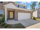A beautifully manicured lawn and stone facade lead to the home's attached two-car garage and front door at 312 Wichita Way, Mcdonough, GA 30253