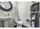 Well-appointed half bathroom with modern fixtures, a pedestal sink, and stylish decor at 312 Wichita Way, Mcdonough, GA 30253
