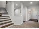 Inviting hallway with staircase, neutral walls, and modern lighting leading to the home's front entrance at 312 Wichita Way, Mcdonough, GA 30253