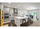 Modern kitchen with stainless steel appliances, white countertops, a center island, and a dining area at 312 Wichita Way, Mcdonough, GA 30253