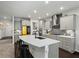 Modern kitchen features a large island, gray cabinets, stainless steel appliances, and sleek countertops at 312 Wichita Way, Mcdonough, GA 30253