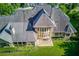 Aerial view of the stunning home showcasing its unique architecture, expansive lawn, and lush surroundings at 5004 Gunnison Trce, Suwanee, GA 30024