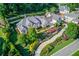 Luxury home with lush landscaping, circular driveway, and attached garage at 5004 Gunnison Trce, Suwanee, GA 30024