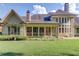 Lovely backyard featuring a stone exterior, a screened porch, and lush green grass at 5004 Gunnison Trce, Suwanee, GA 30024