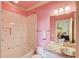 Pink bathroom with a shower, bathtub, patterned tile, and unique glass sink at 5004 Gunnison Trce, Suwanee, GA 30024