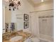 Elegant bathroom featuring granite countertop, decorative light fixture, and shower-tub combination at 5004 Gunnison Trce, Suwanee, GA 30024