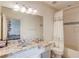 Bright bathroom featuring marble counters, a shower and tub combo at 5004 Gunnison Trce, Suwanee, GA 30024