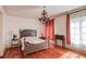 Bedroom featuring a chandelier, hardwood floors, and a window with lots of natural light at 5004 Gunnison Trce, Suwanee, GA 30024