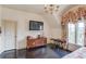 Bedroom featuring hardwood floors, an oriental chest and a tv at 5004 Gunnison Trce, Suwanee, GA 30024