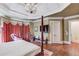 Spacious bedroom featuring a canopy bed, tray ceiling, and ample natural light, ideal for relaxation at 5004 Gunnison Trce, Suwanee, GA 30024